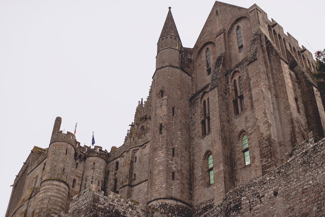 Brick Gothic abbey castle against gray sky