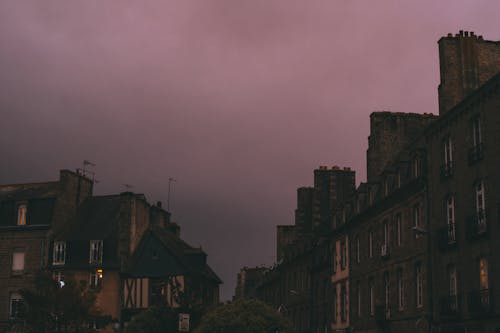 Town street under dark purple sunset cloudy sky