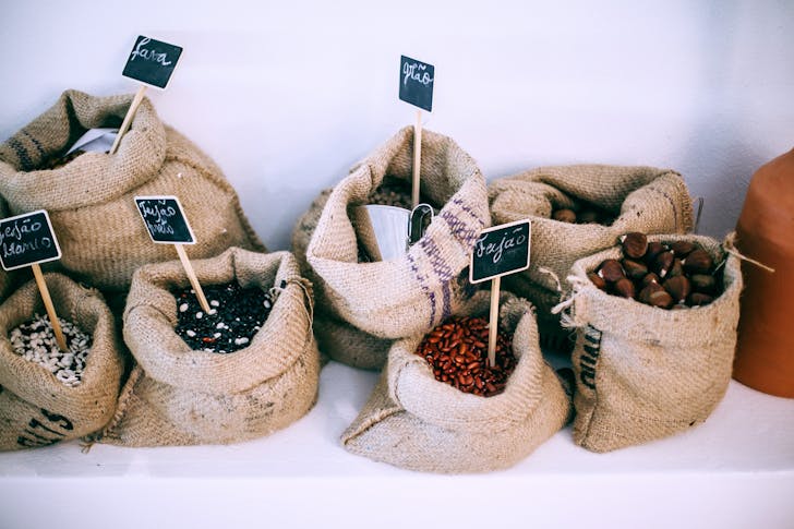 Different types of beans in sacks with inscriptions