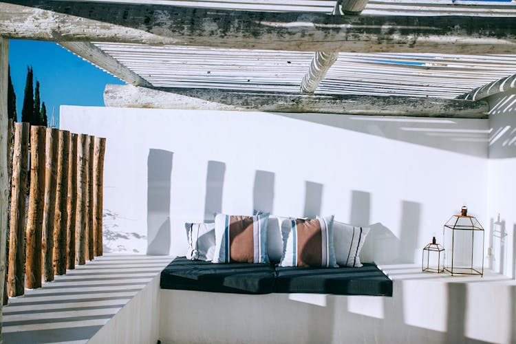 Fabric With Decorative Cushions Under Wooden Roof On Terrace