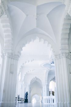 Old stone palace interior with sculpture in corridor