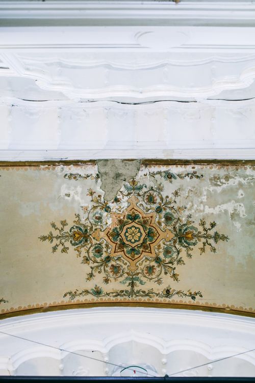 Free Interior of old stone building with shabby painting on ceiling in structure with classic style Stock Photo