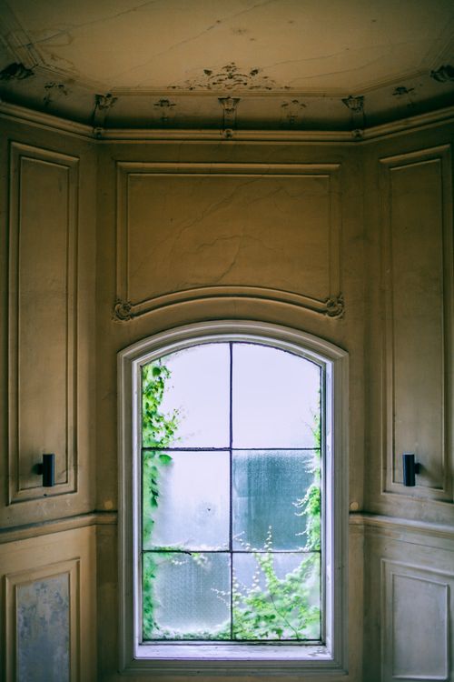 Free High ornamental ceiling over stone walls and classic window with lattice in building Stock Photo