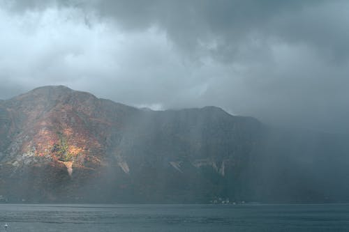 Rocky cliff in calm sea water