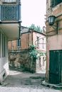 Narrow pedestrian street between shabby residential buildings