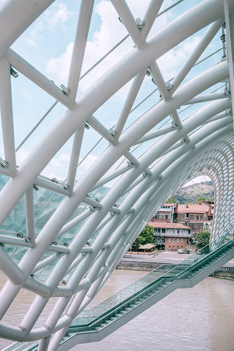 Futuristic Geometric Pedestrian Bridge Over City River