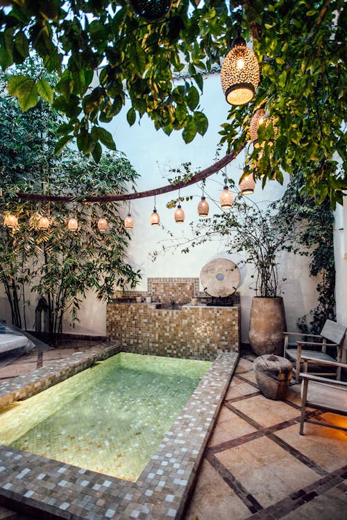 Free Traditional oriental hammam pool on exotic resort spa terrace decorated with lush plants  and stylish lanterns Stock Photo