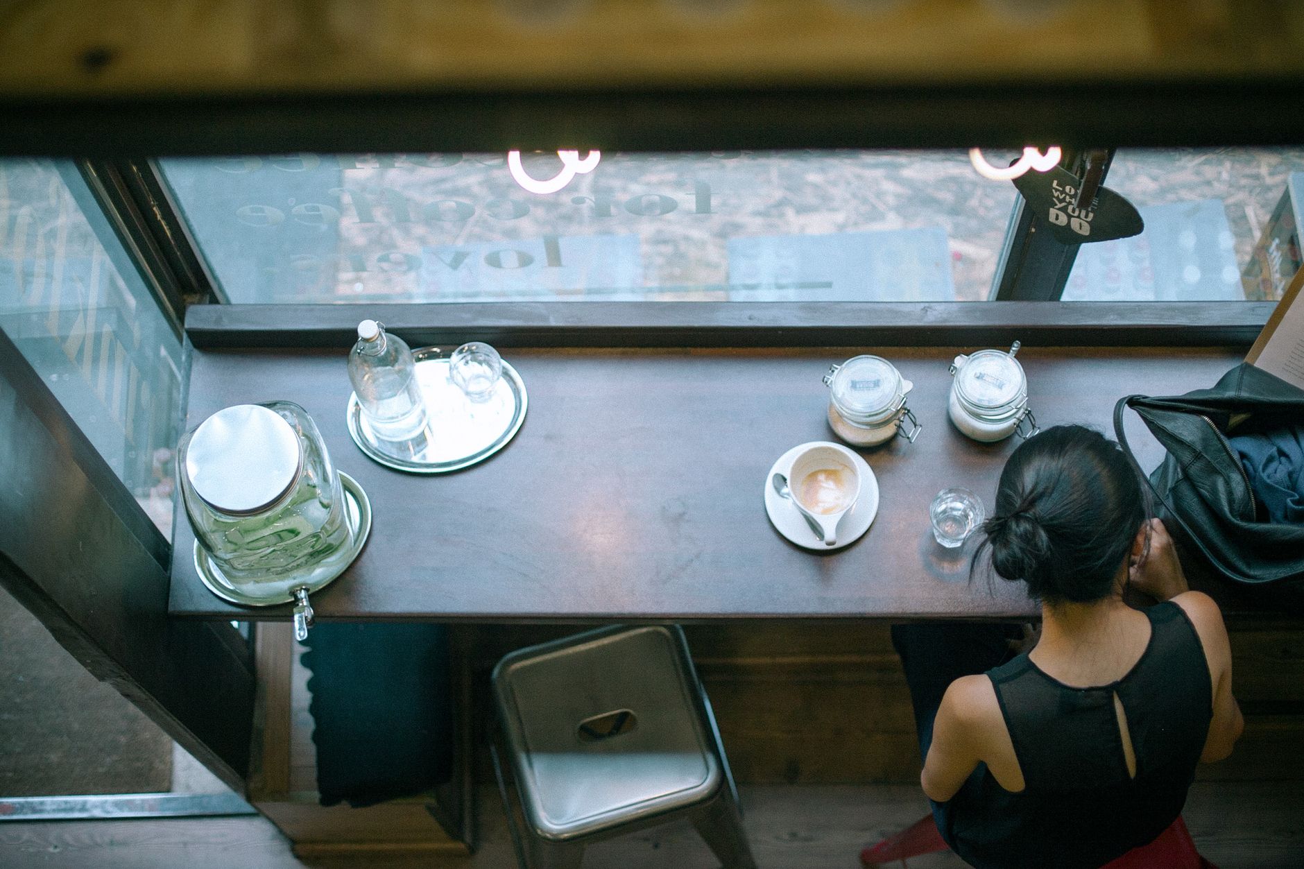 Freshly brewed espresso shot with crema atop white ceramic cup on wooden table