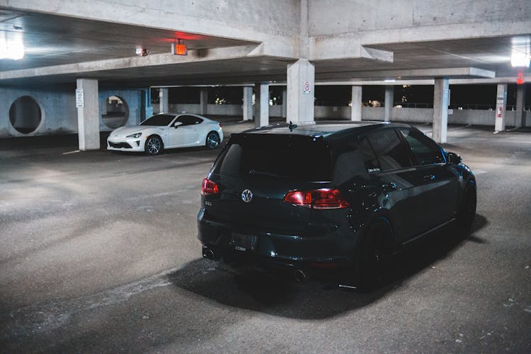 Modern Black Car On Concrete Parking Lot