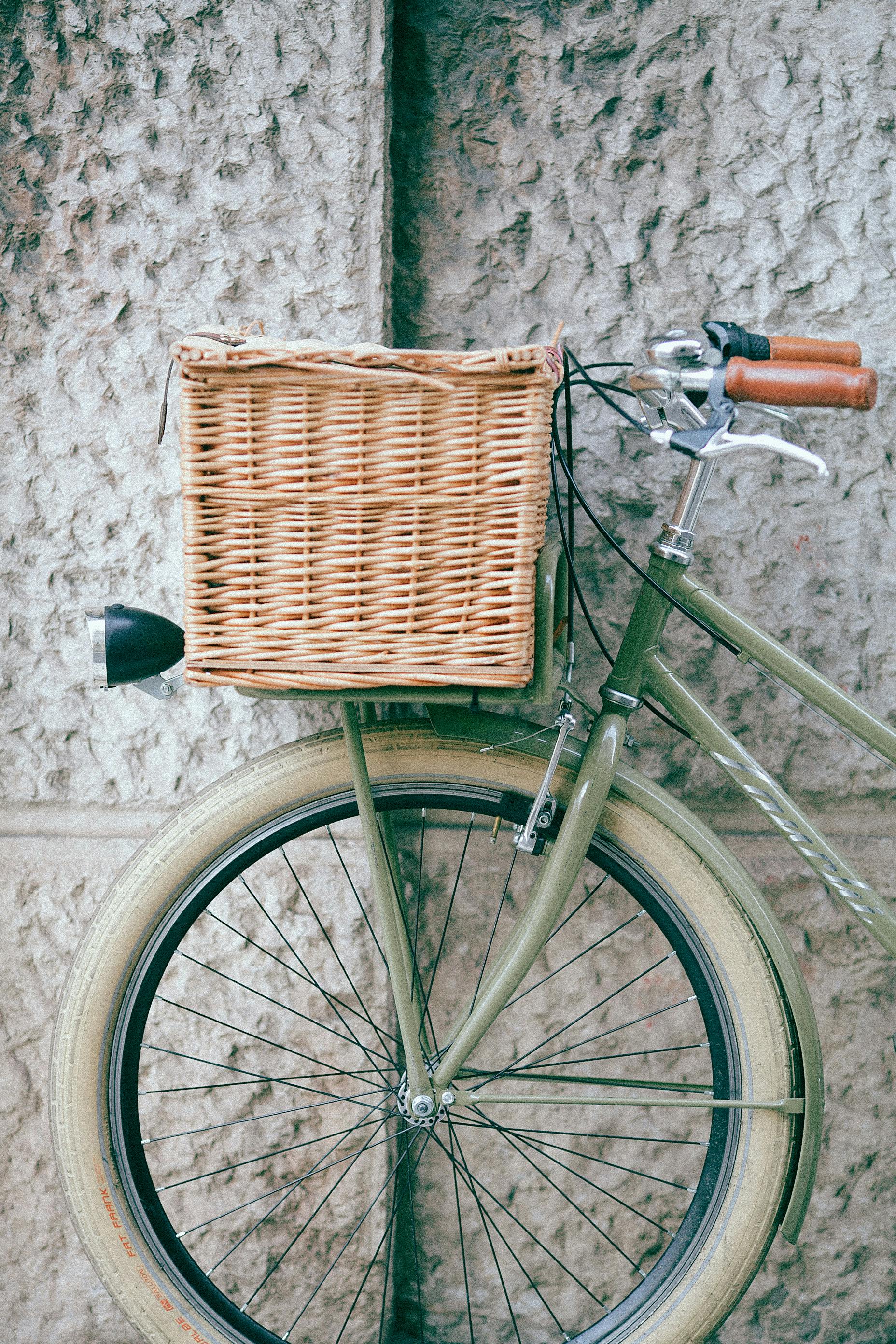 vintage bicycle with basket near wall