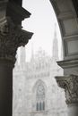 Aged stone columns of medieval Gothic cathedral with arch windows and ornate elements