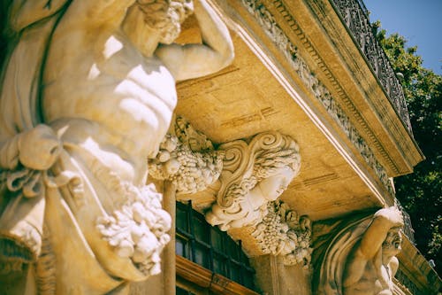 Ancient statues near entrance in old building