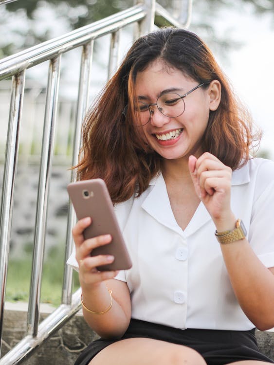 
A Happy Woman Using Her Smartphone