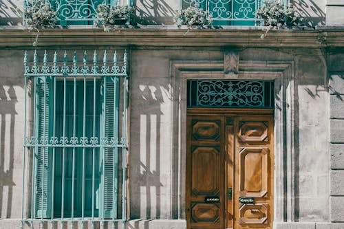 Entrance door of old stone house with decorative fences