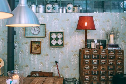 Free Interior of cozy vintage styled apartment with aged wooden furniture and old fashioned clocks and lamps Stock Photo