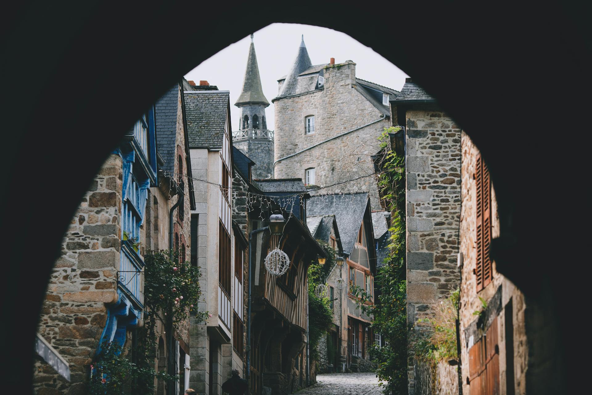 Narrow street of old town with arched passage and typical stone houses