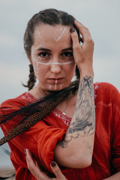 Woman with Face Paint Wearing a Red Blouse 