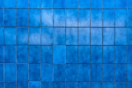 A Wall with Blue Rectangular Discolored Tiles