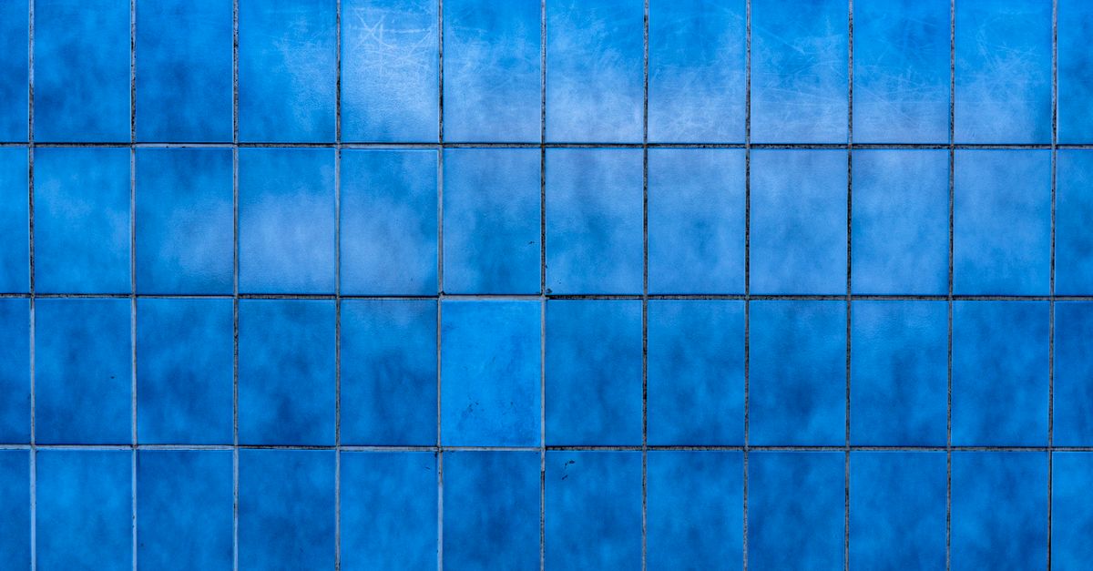 Rectangular Blue Wall A Wall with Blue Rectangular Discolored Tiles · Free Stock Photo