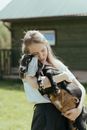 Girl in White Tank Top Holding Black and White Monkey Plush Toy