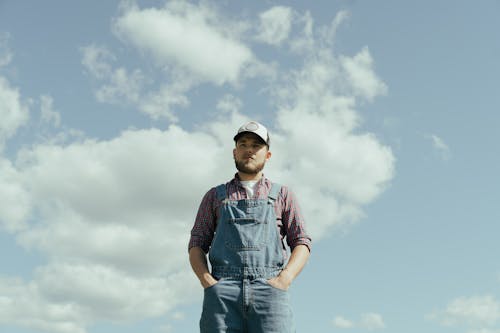 Man in Red and Gray Stripe Crew Neck T-shirt and Blue Denim Jeans