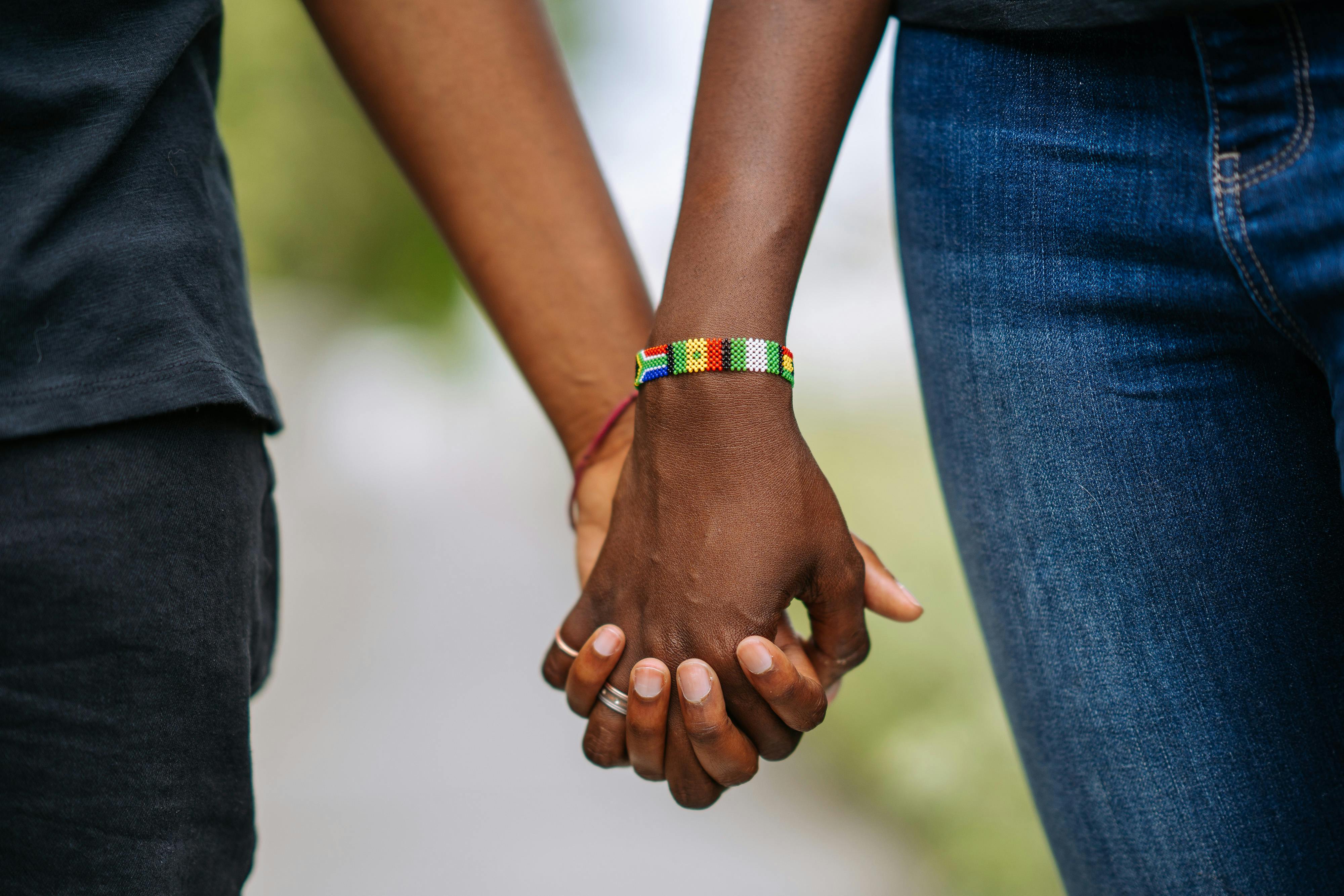 close up photo of couple holding each other s hands