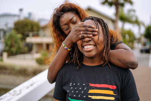 Heartfelt moment of a joyful LGBTQ couple embracing on a sunny day.