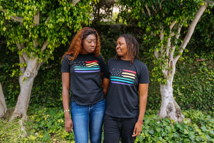 A Couple In Matching Shirts Looking At Each Other