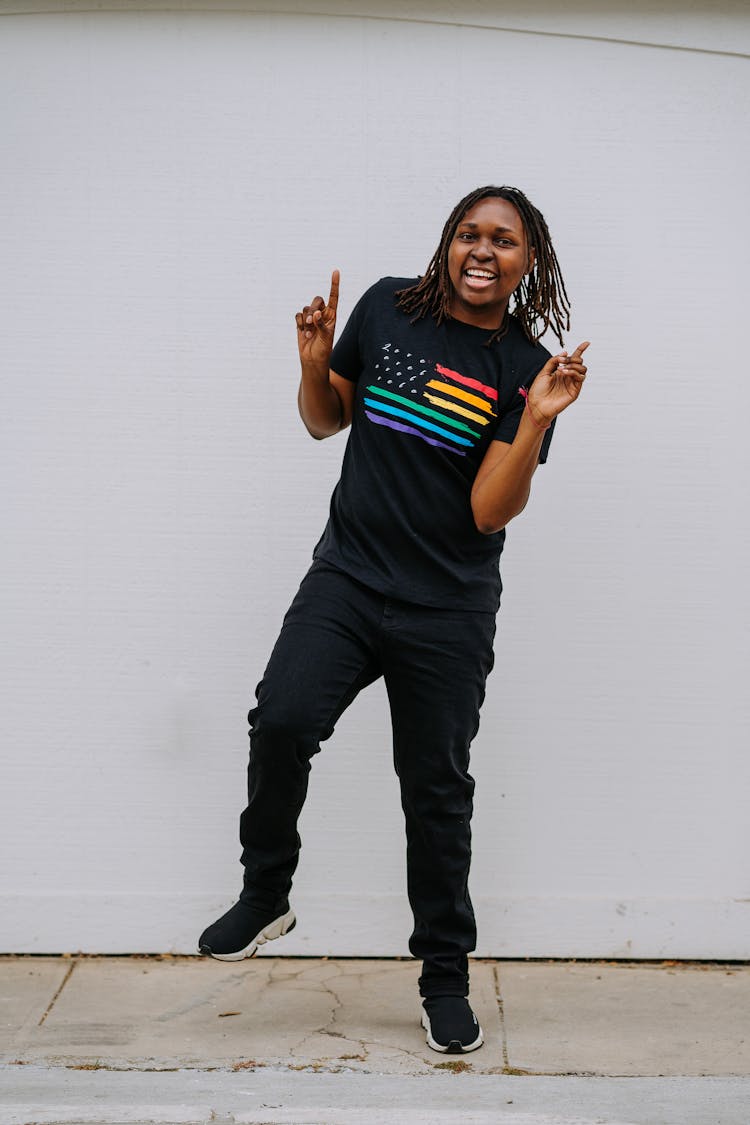 A Happy Woman In A Gay Pride Shirt Dancing