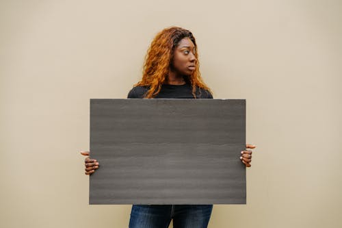 A Woman Holding a Blank Placard