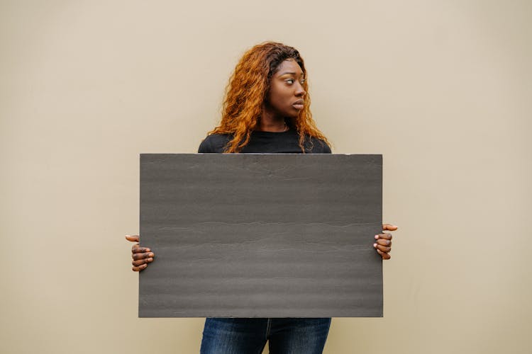 A Woman Holding A Blank Placard