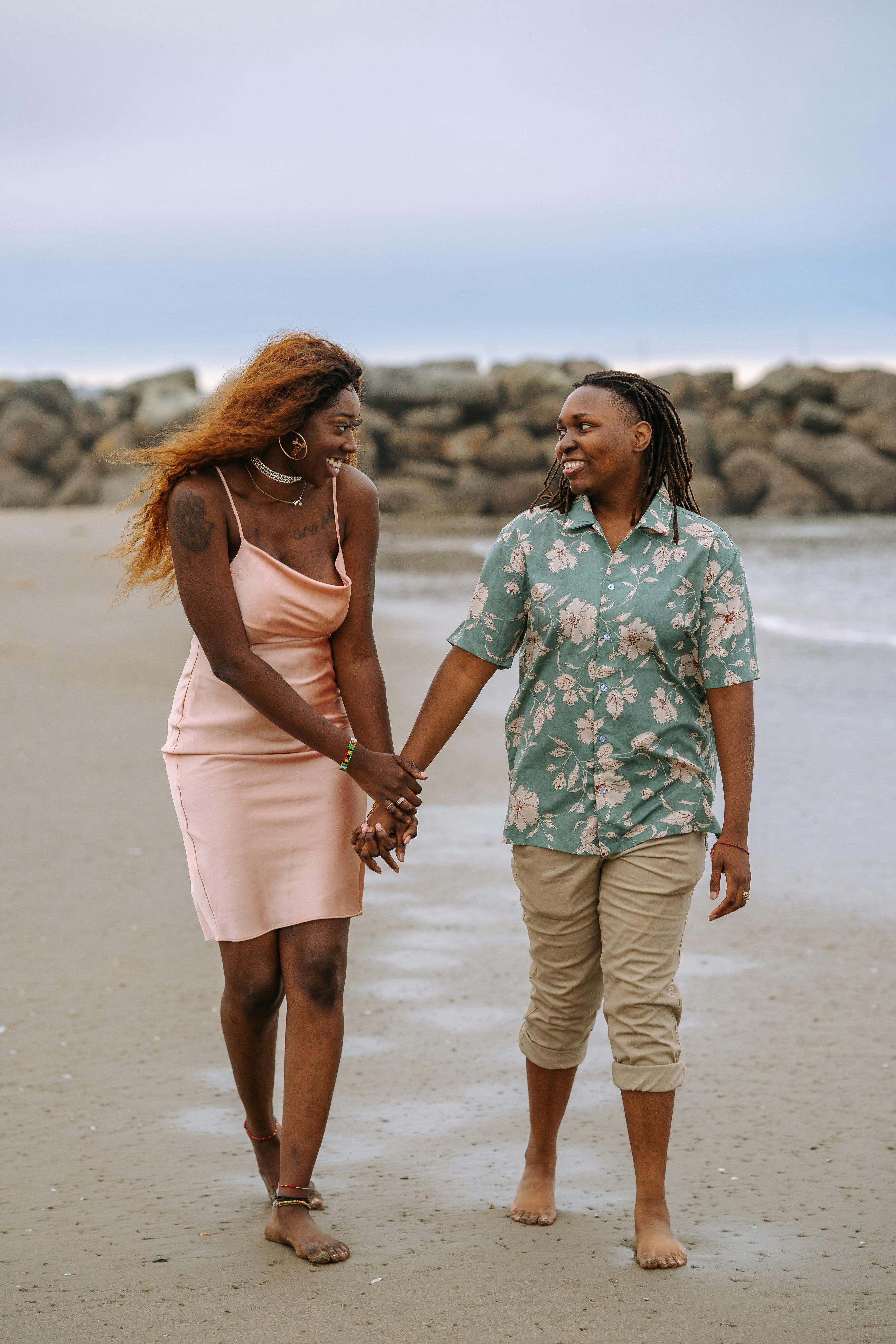 2 women standing on beach