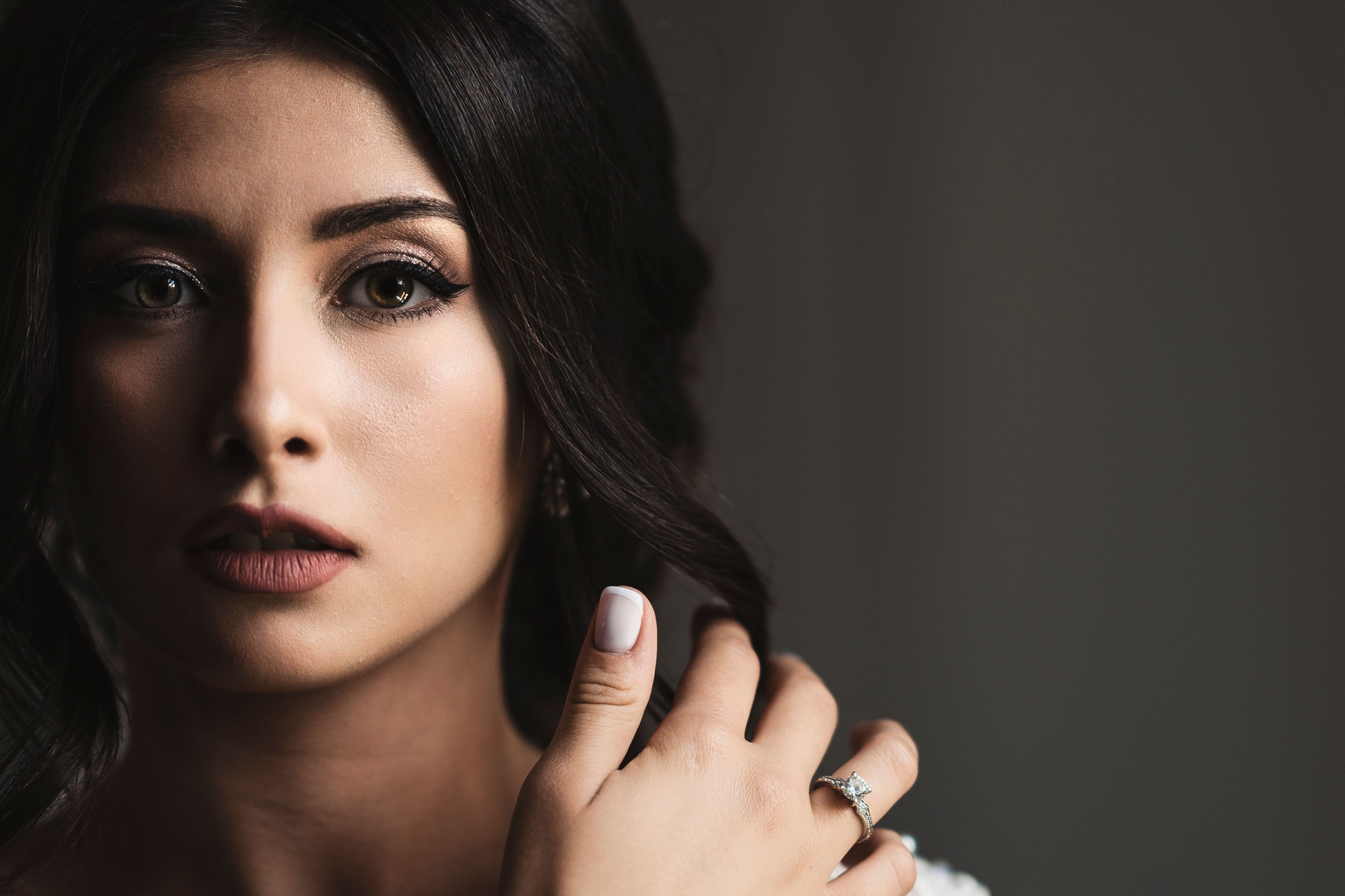 Close-up bridal portrait showing elegance and beauty with focus on engagement ring.