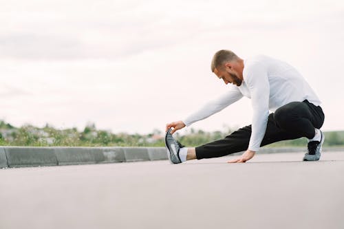 Free Man doing Stretching Exercises Stock Photo