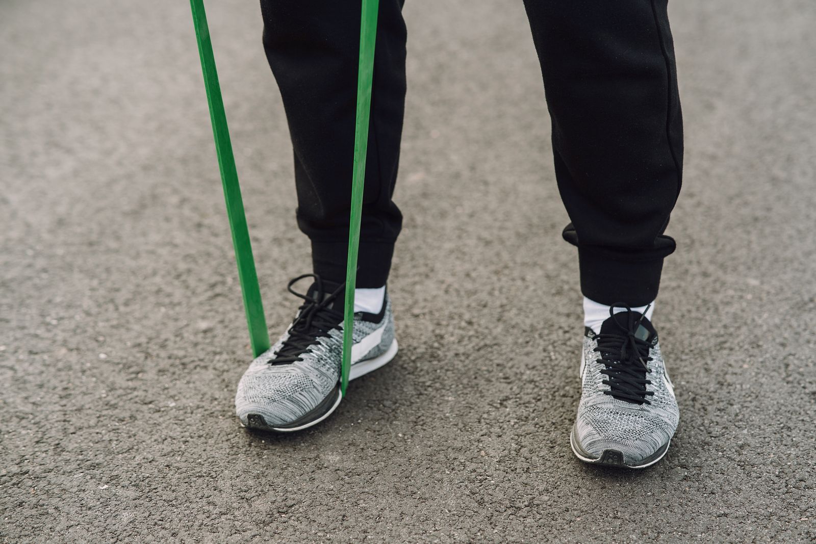 Runner adjusting an ankle before an outdoor trail session
