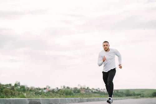 Free Man in White Long Sleeve doing Running Exercises  Stock Photo