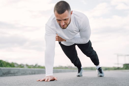 Athletic man doing plank exercise outdoors for fitness and core strength.