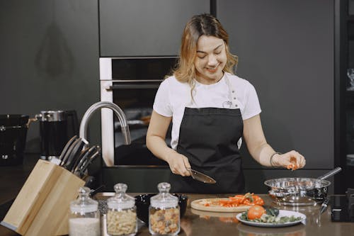 Woman slicing Food on Kitchen Counter