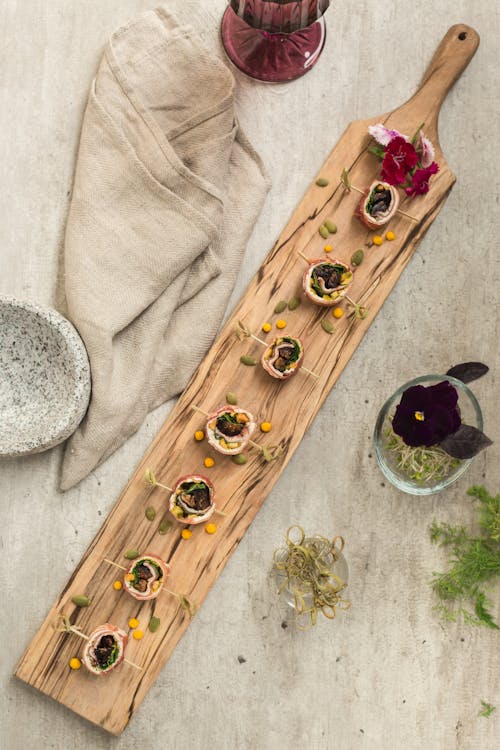 A Food Photography of Rolled Food on a Wooden Board