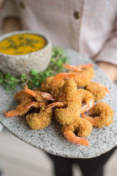 A Food Plating of Breaded Shrimp on Oval Tray