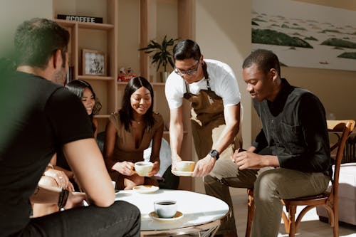 Waiter serves Coffee on Table 