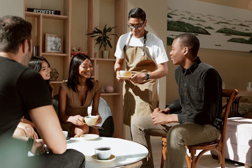 Waiter serves Coffee on Table 