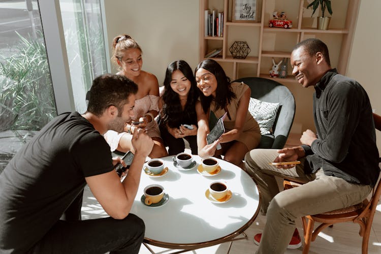 Group Of Friends Bonding Together In A Cafe