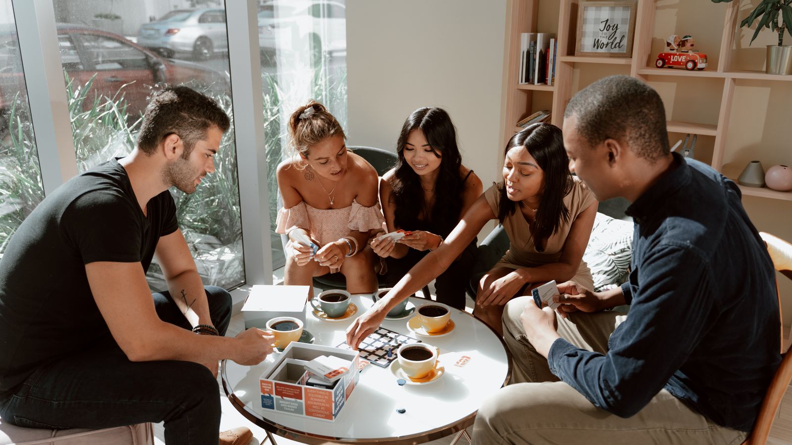 Adults playing a board game around a café table