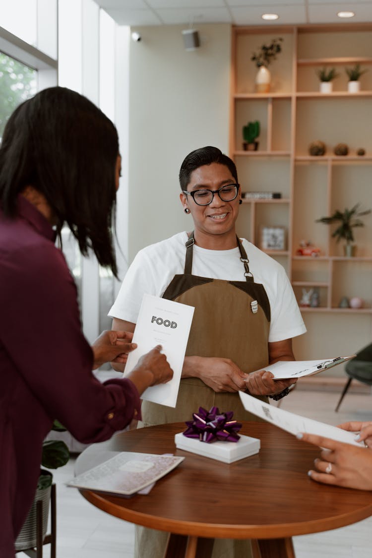 Waiter Standing In Front Of A Customer 