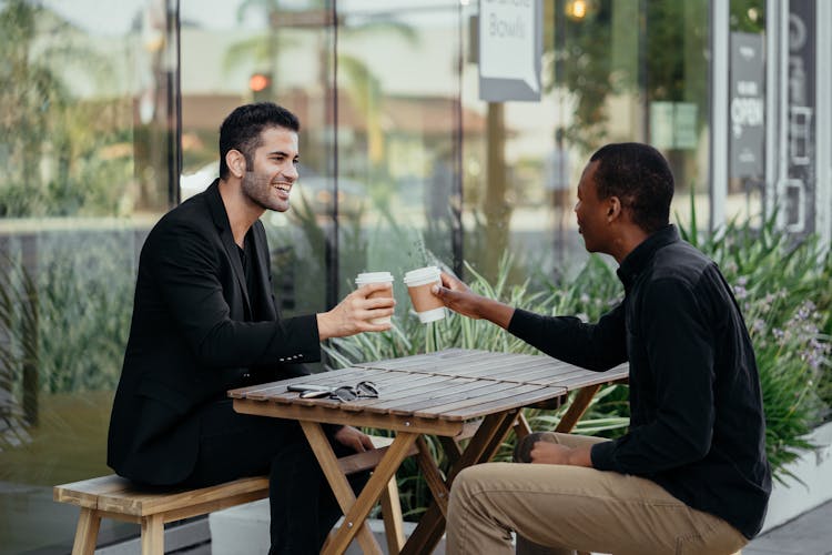 Happy Male Colleagues Talking To Each Other