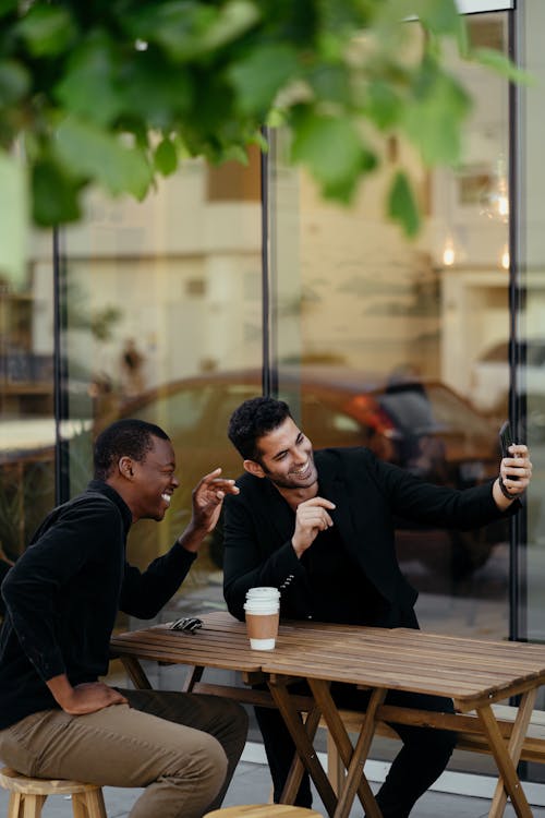 Free Two Men Smiling While Taking a Selfie Stock Photo