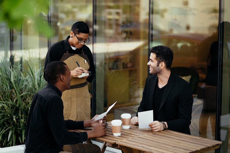 Waiter Getting The Customer's Orders