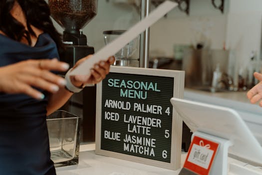 Coffee shop scene with a letter board showing seasonal menu items like Iced Lavender Latte.