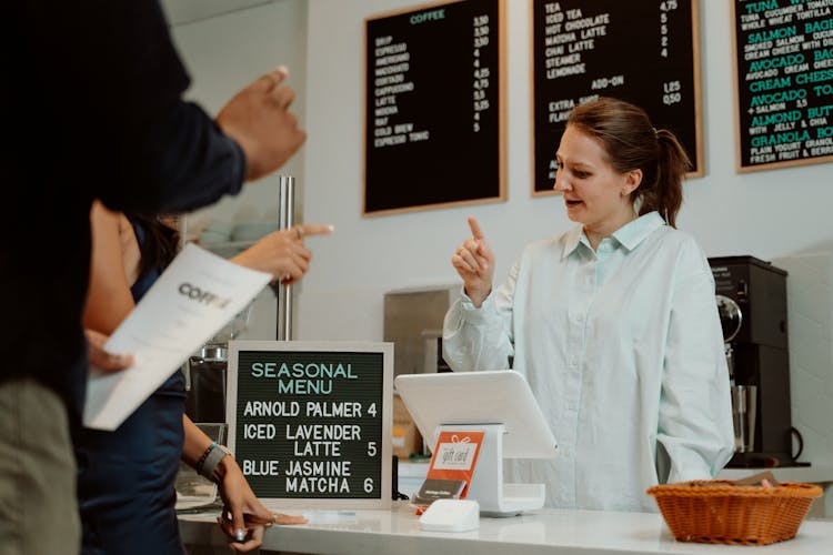 Cashier Taking Orders From Customers